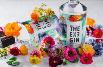 Two The Exe Gin bottles surrounded by flowers
