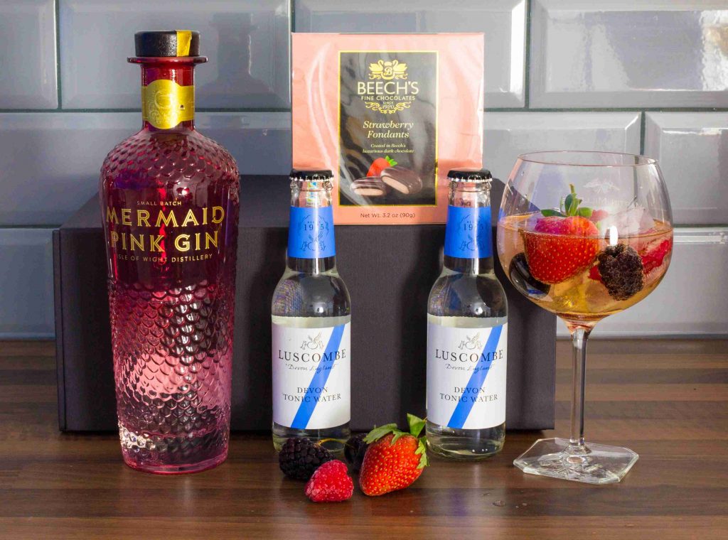 Mermaid on counter - with goblet, ice, fruit in glass with gin