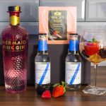 Mermaid on counter - with goblet, ice, fruit in glass with gin