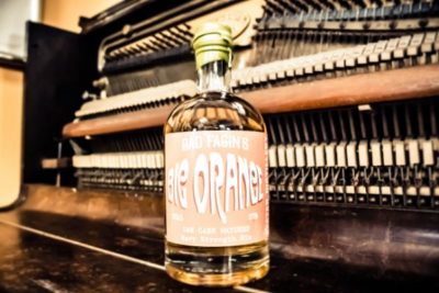 Bad Fagin's Big Orange Gin on a closed piano