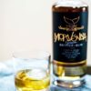 Morvenna Spiced Rum blurred in the background with a short cocktail in the foreground