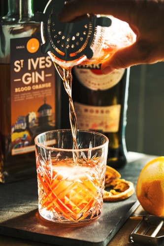 St-Ives-Blood-Orange-martini-cocktail-being-poured-with-bottle-in-the-background