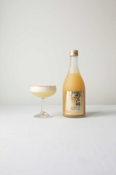 Ginjo Yuzushu Sake bottle next to a Yuzurita cocktail